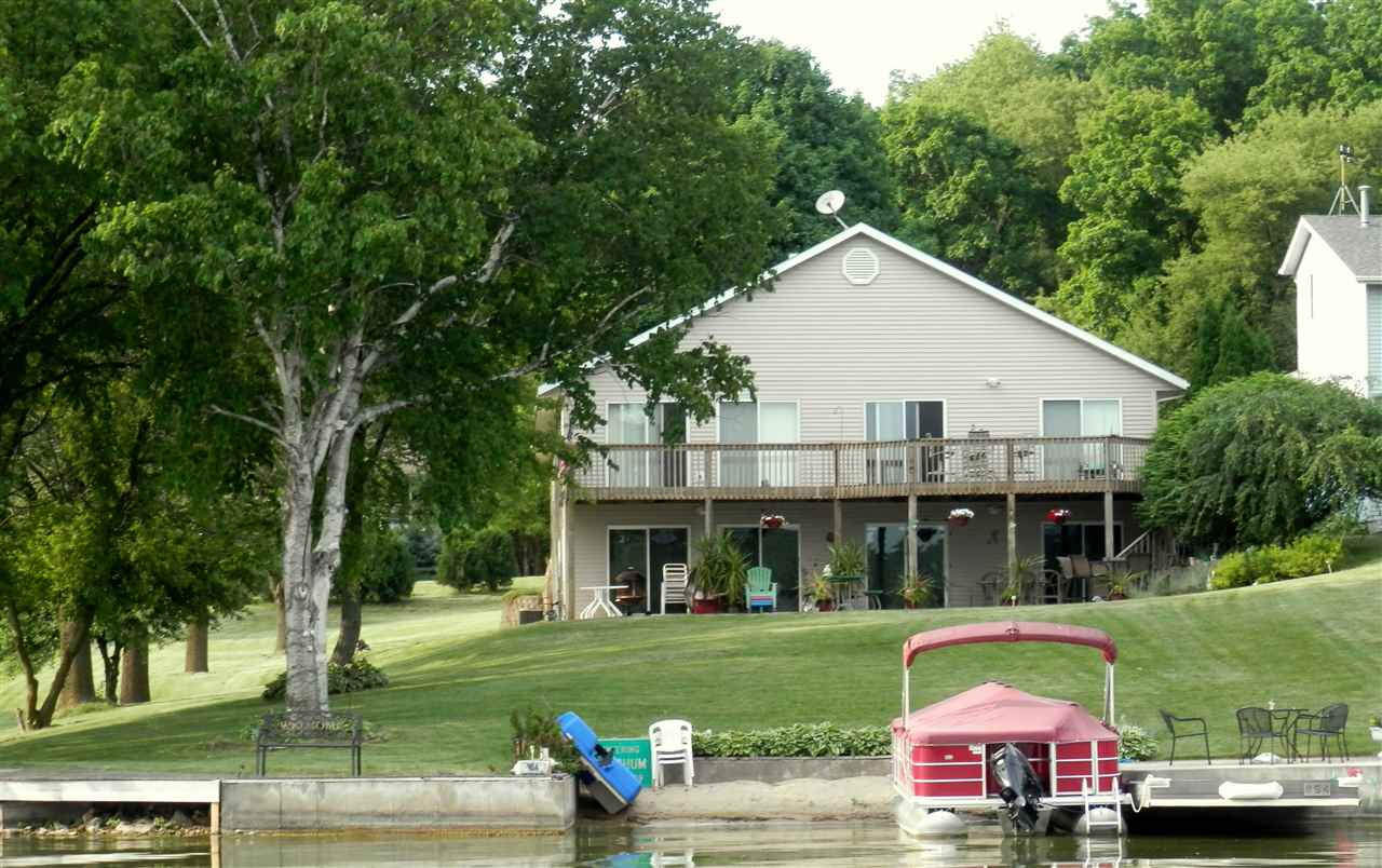 854 Breckenboro Road Lake Summerset, IL 61019 - Photo 12 of 24 a view of a white house with a big yard and large trees