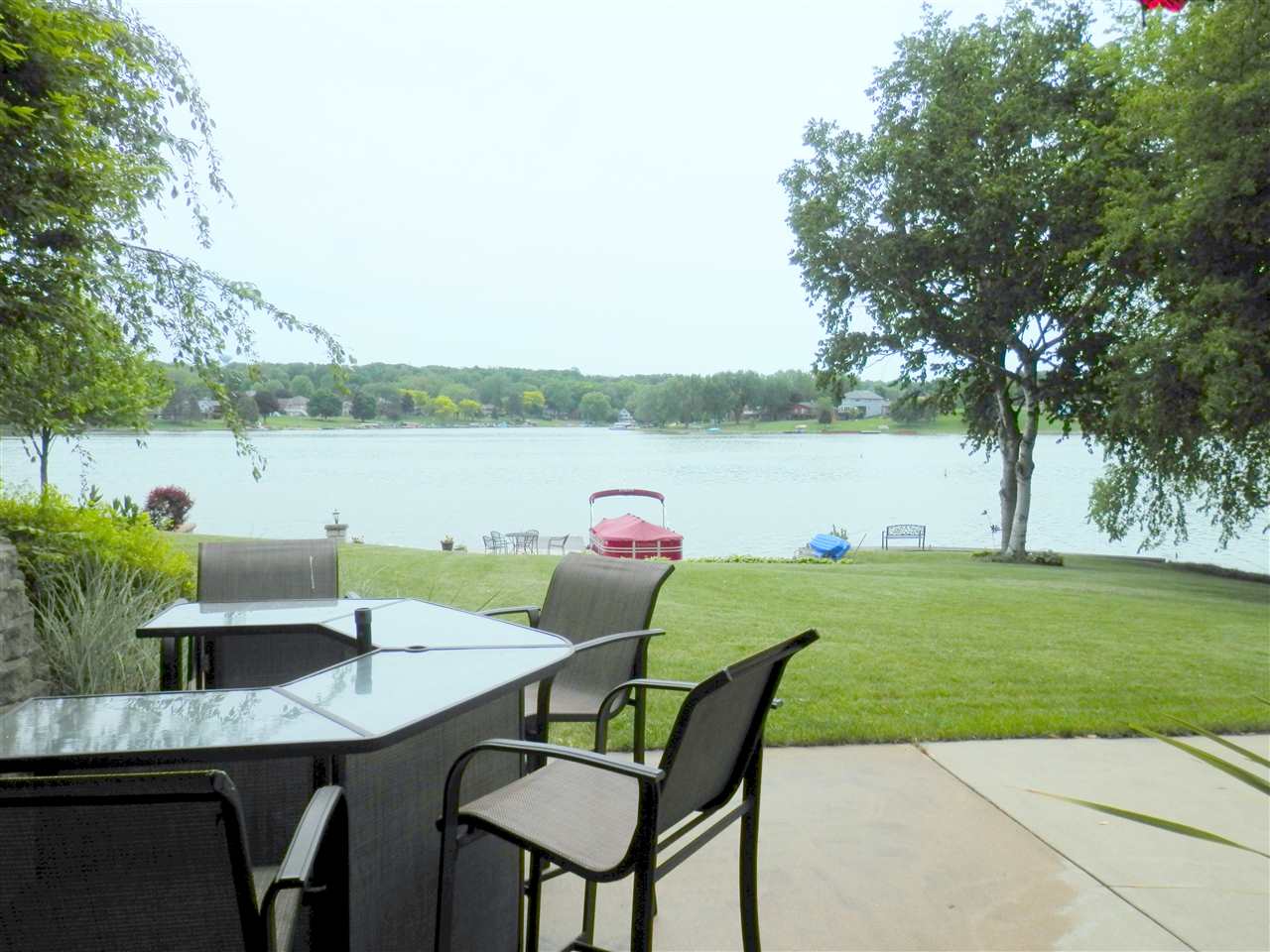 854 Breckenboro Road Lake Summerset, IL 61019 - Photo 22 of 24 a view of a lake with a table and chairs