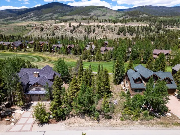 an aerial view of residential houses with outdoor space and river
