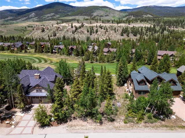 an aerial view of residential houses with outdoor space and river