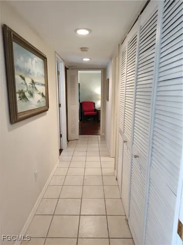 a view of a hallway and closet with furniture