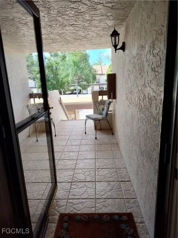 a view of a balcony with chair and table