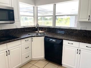 22175 General Street Boca Raton, FL 33428 - Photo 11 of 32 a kitchen with granite countertop white cabinets white appliances and a sink