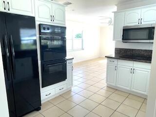 22175 General Street Boca Raton, FL 33428 - Photo 13 of 32 a kitchen with granite countertop white cabinets and stainless steel appliances