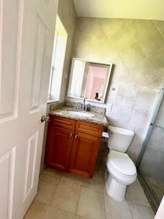22175 General Street Boca Raton, FL 33428 - Photo 27 of 32 a bathroom with a granite countertop toilet and a sink