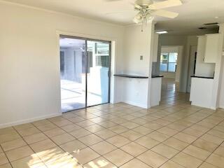 22175 General Street Boca Raton, FL 33428 - Photo 6 of 32 a view of a kitchen with wooden floor and a refrigerator