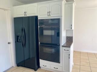 22175 General Street Boca Raton, FL 33428 - Photo 9 of 32 a kitchen with granite countertop a refrigerator and a stove top oven