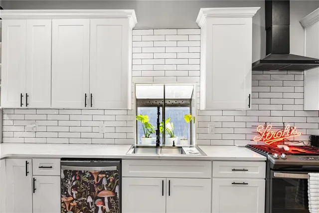 a kitchen with stainless steel appliances a sink and cabinets