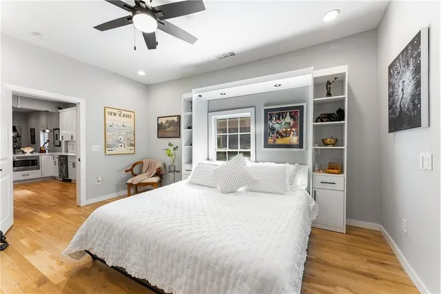 a bedroom with a large bed and a chandelier