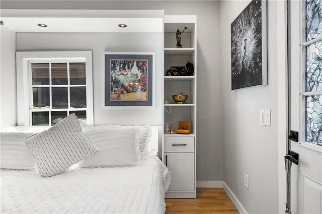 a bedroom with a bed and a window