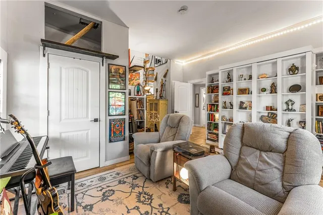 a living room with furniture a rug and a window