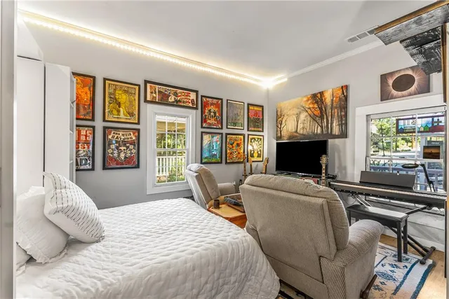 a bedroom with furniture and a flat screen tv