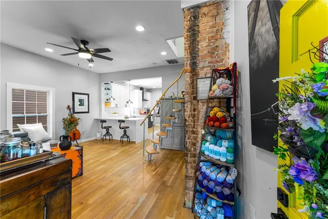 a living room filled with furniture and a potted plant