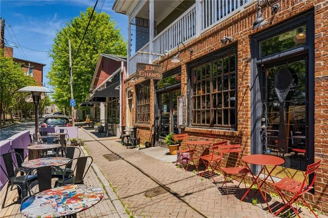 a view of a brick building with a bench in front of building