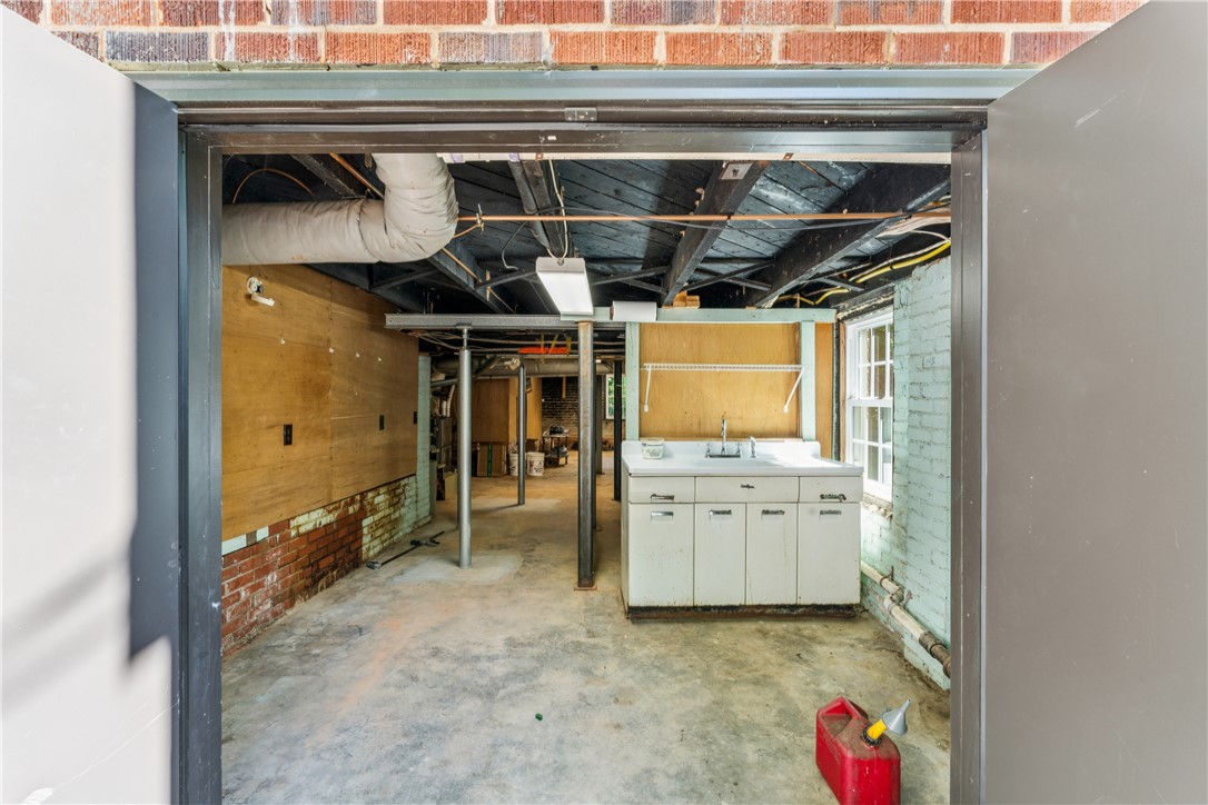 321 South Pine Street Walhalla, SC 29691 - Photo 28 of 32 Functional utility space with exposed brick, offering practical amenities for daily tasks.