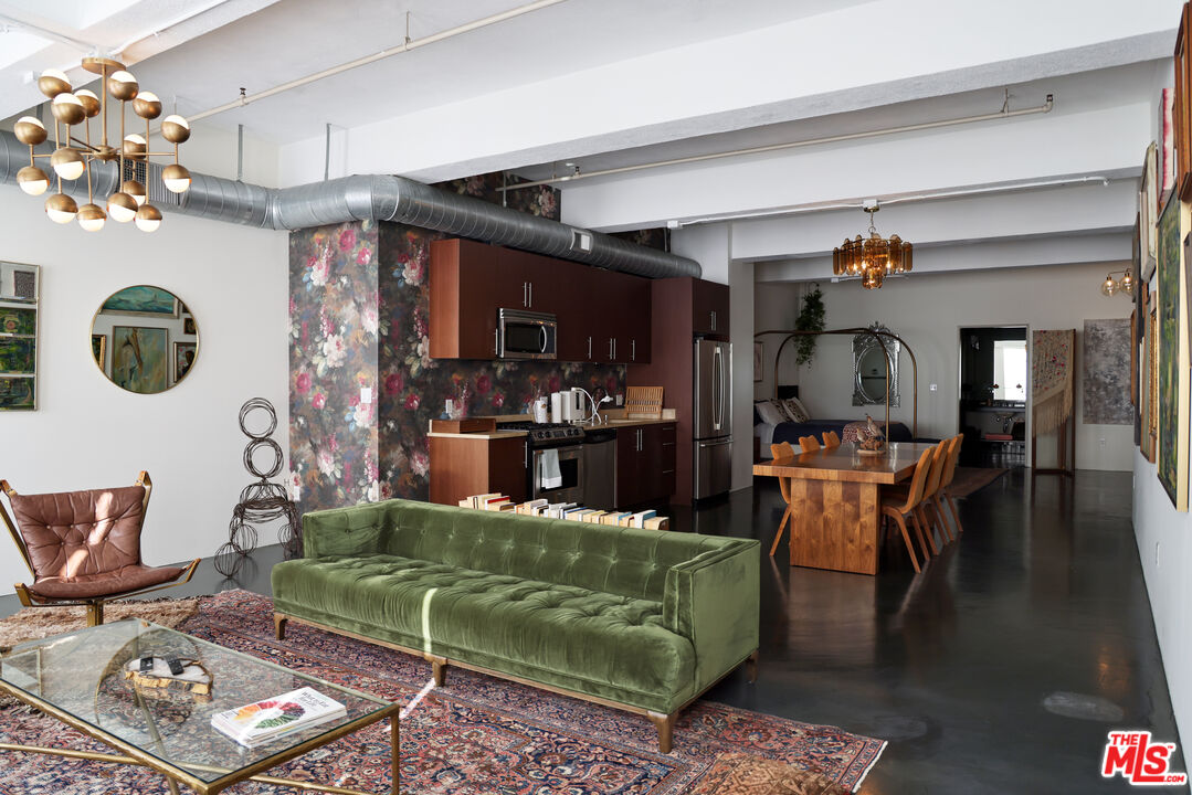 849 South Broadway, Unit 906 Los Angeles, CA 90014 - Photo 12 of 65 a living room with furniture and a chandelier