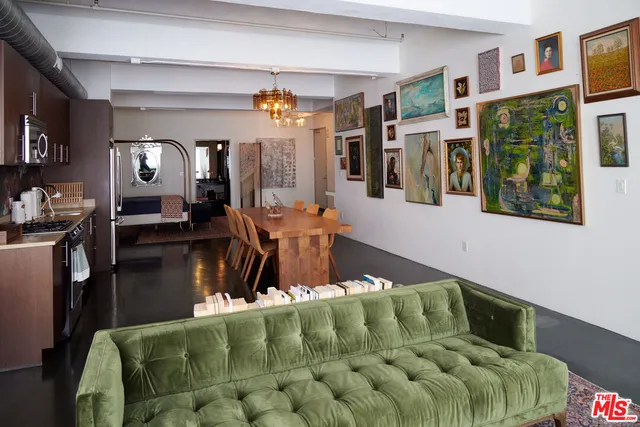 a living room with furniture a flat screen tv and a dining table