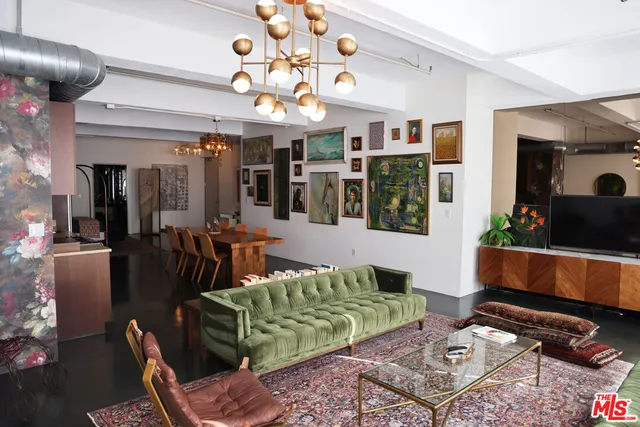 a living room with furniture a flat screen tv and potted plant