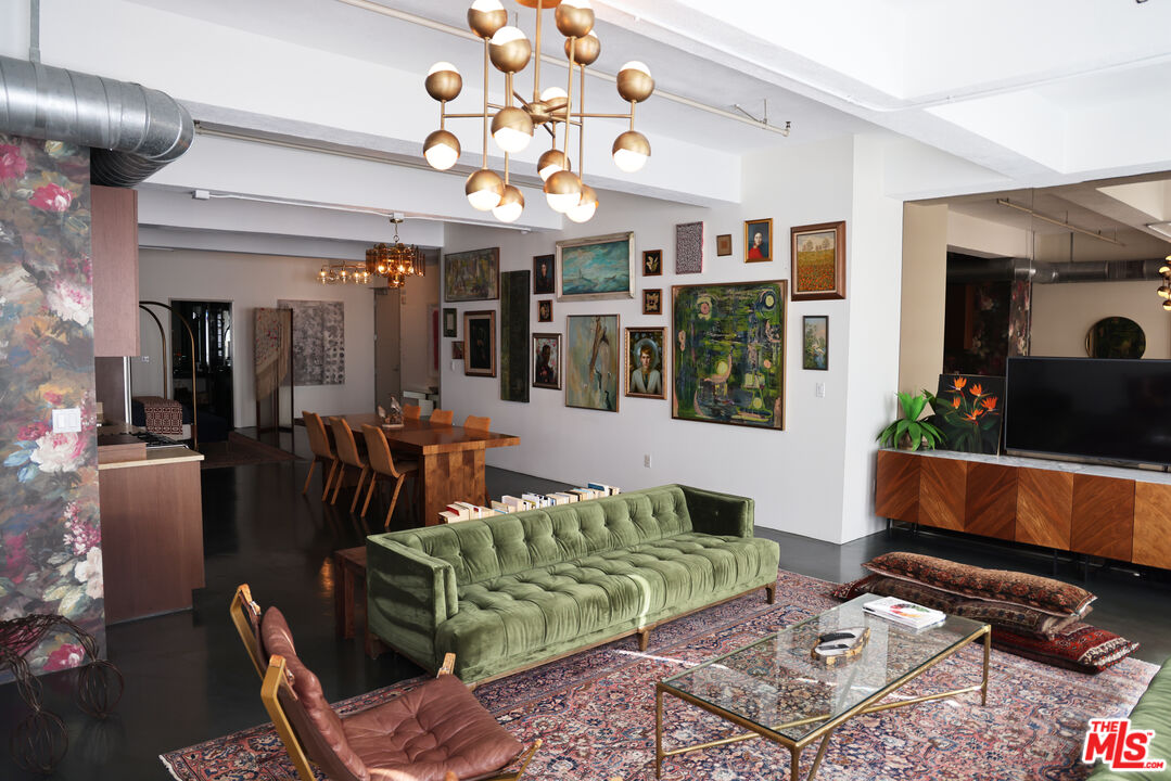 849 South Broadway, Unit 906 Los Angeles, CA 90014 - Photo 14 of 65 a living room with furniture a flat screen tv and a dining table