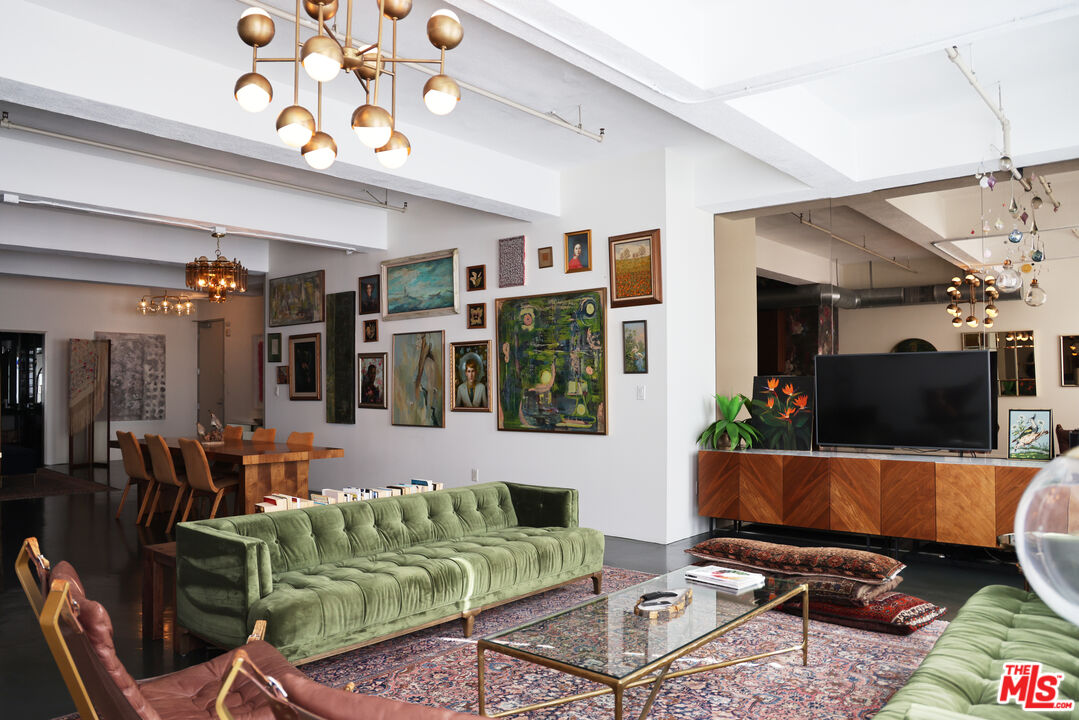 849 South Broadway, Unit 906 Los Angeles, CA 90014 - Photo 15 of 65 a living room with furniture a flat screen tv and potted plant