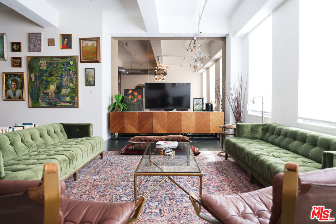 849 South Broadway, Unit 906 Los Angeles, CA 90014 - Photo 16 of 65 a living room with furniture and a flat screen tv
