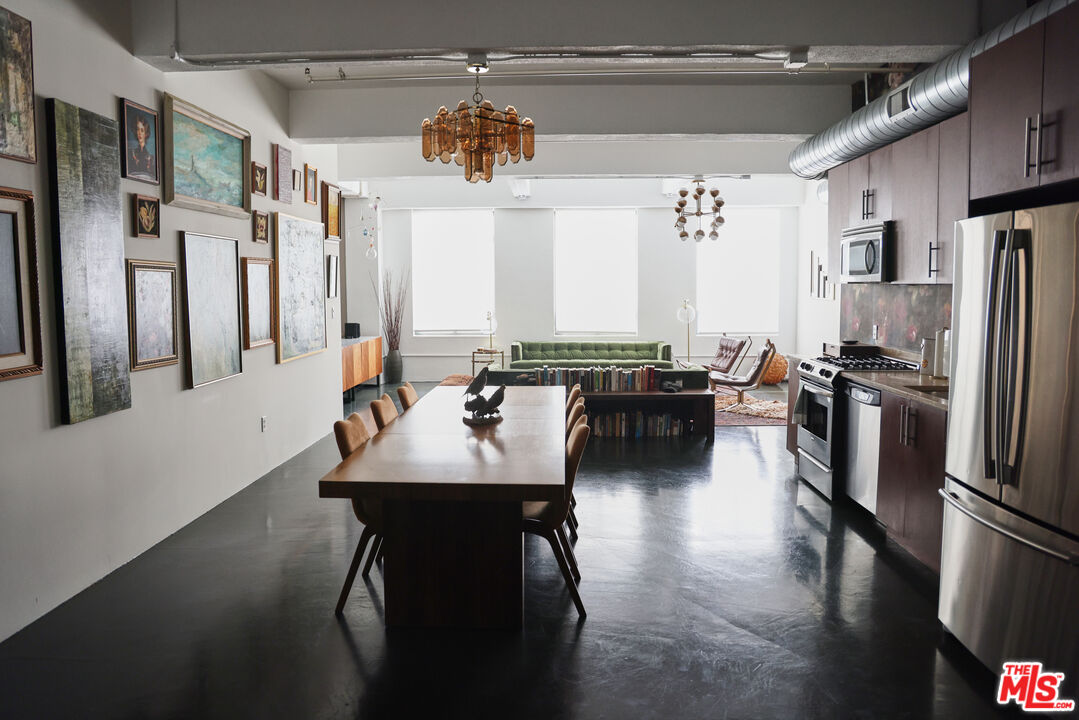 849 South Broadway, Unit 906 Los Angeles, CA 90014 - Photo 20 of 65 a kitchen with stainless steel appliances granite countertop a sink a stove and refrigerator