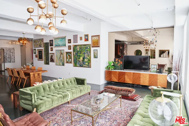 a living room with furniture windows and a chandelier