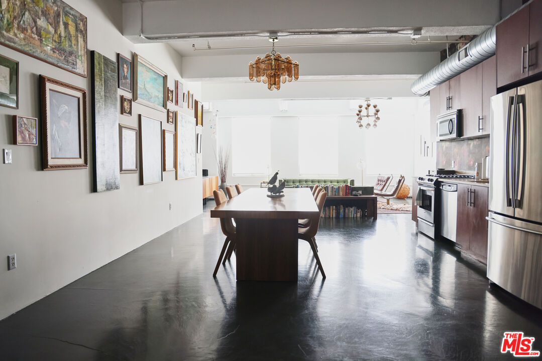 849 South Broadway, Unit 906 Los Angeles, CA 90014 - Photo 23 of 65 a view of a dining room with furniture window and wooden floor