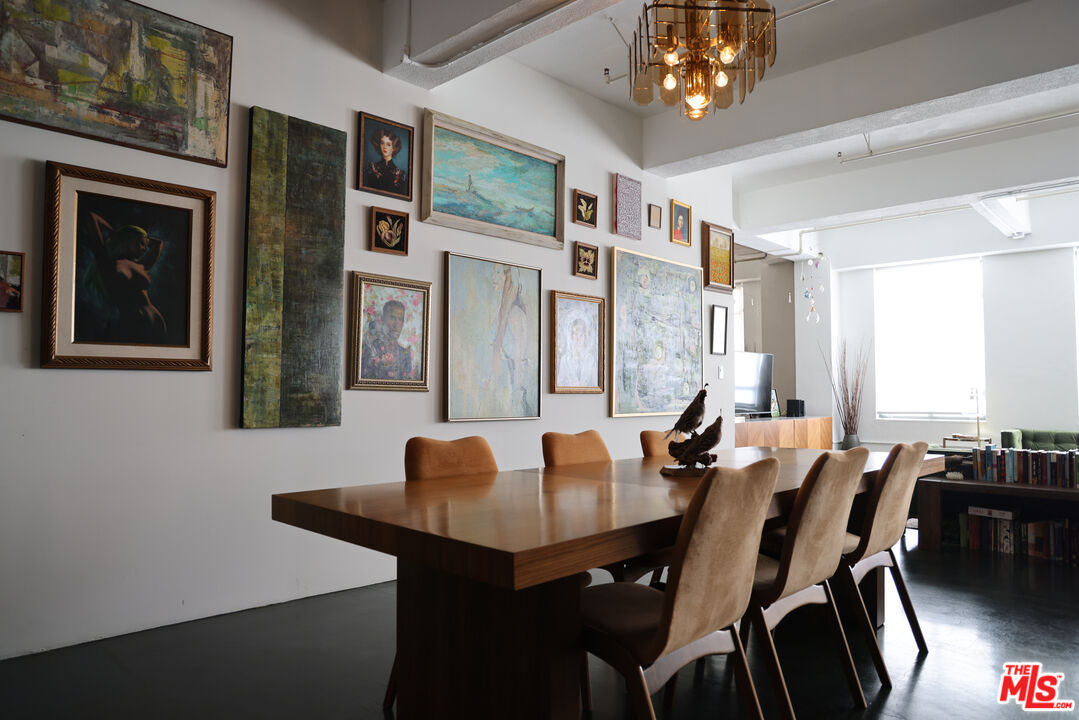849 South Broadway, Unit 906 Los Angeles, CA 90014 - Photo 26 of 65 a view of a dining room with furniture and chandelier