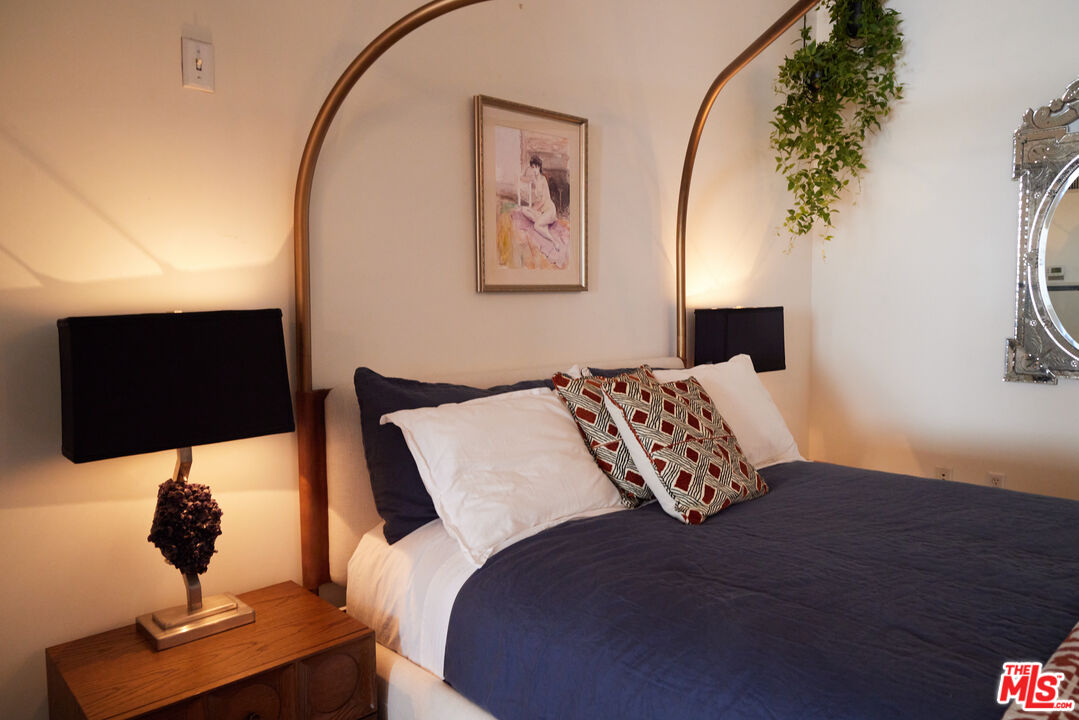 849 South Broadway, Unit 906 Los Angeles, CA 90014 - Photo 39 of 65 a living room with a bed furniture and a flat screen tv