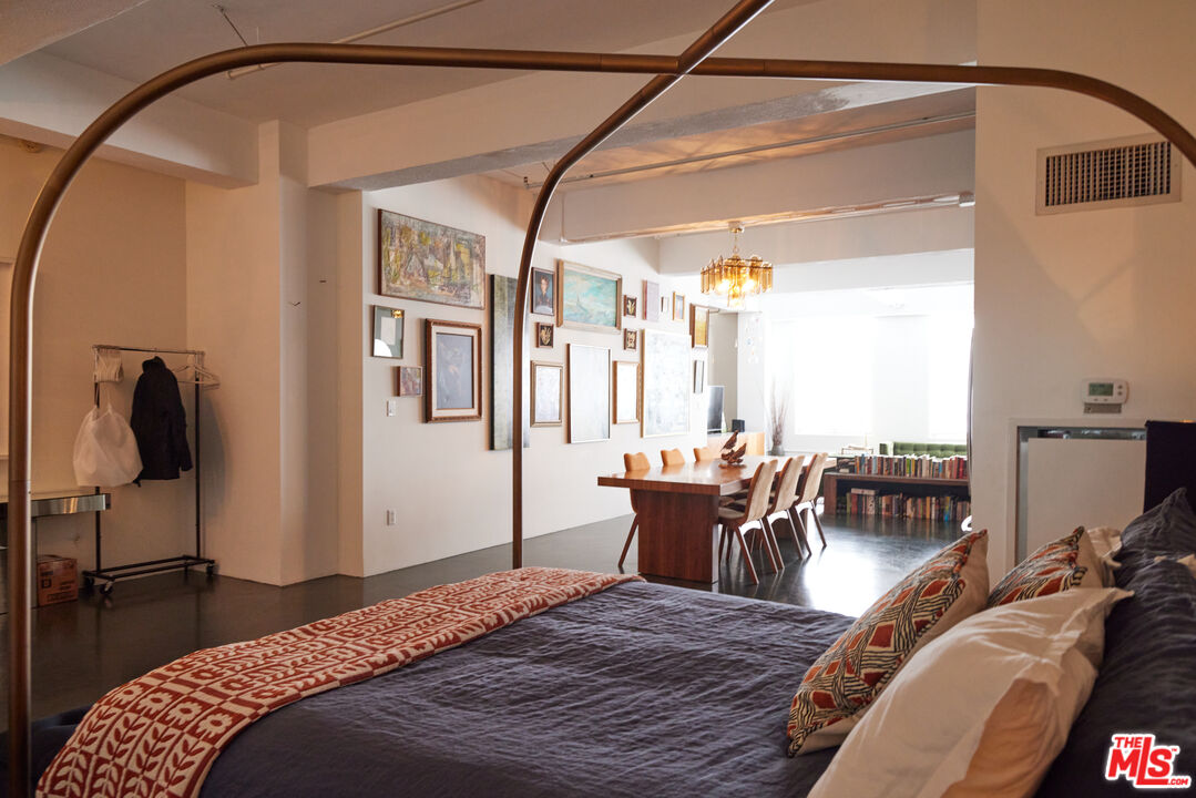 849 South Broadway, Unit 906 Los Angeles, CA 90014 - Photo 42 of 65 a bedroom with a bed and wooden floor