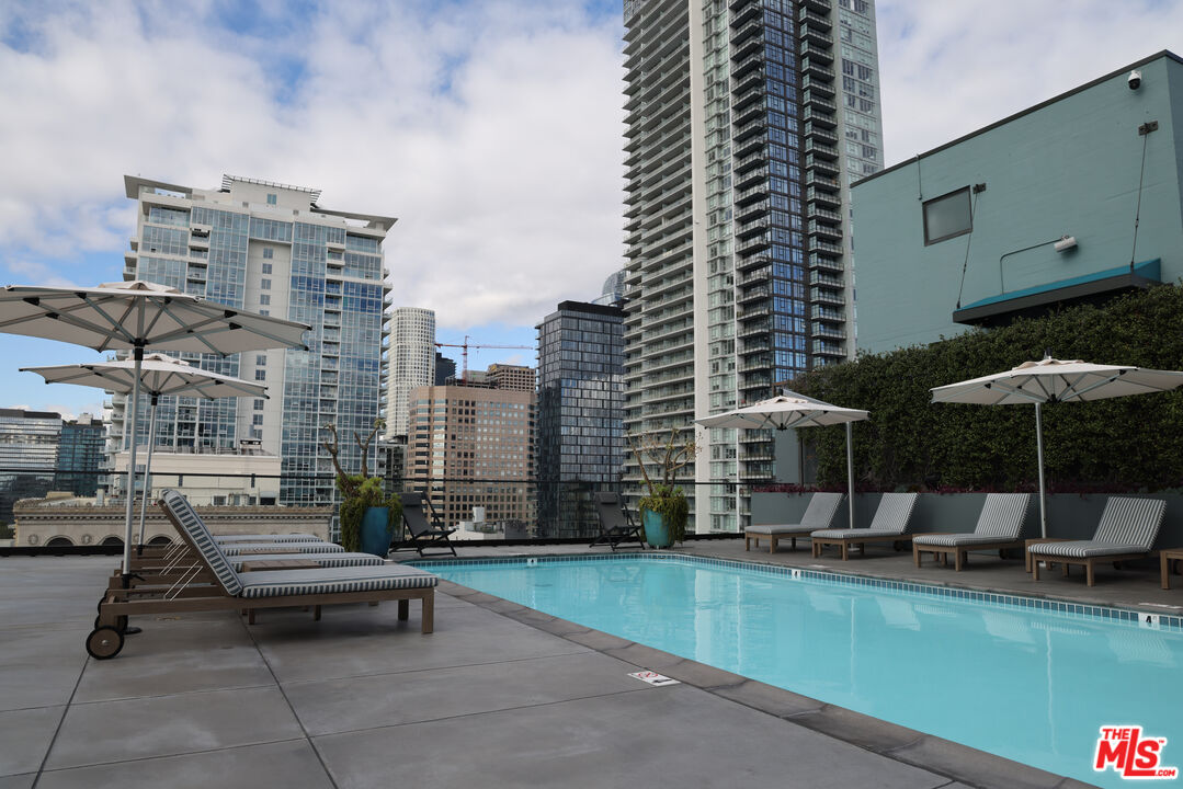 849 South Broadway, Unit 906 Los Angeles, CA 90014 - Photo 46 of 65 a roof deck with outdoor seating and city view