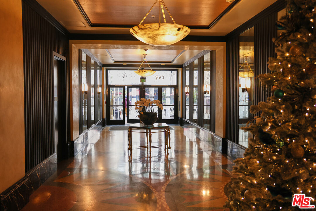 849 South Broadway, Unit 906 Los Angeles, CA 90014 - Photo 60 of 65 a view of a dining room with furniture wooden floor and chandelier