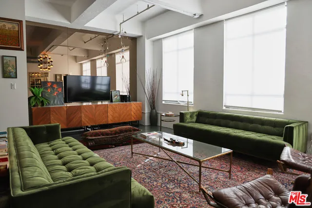 a living room with furniture rug and wooden floor
