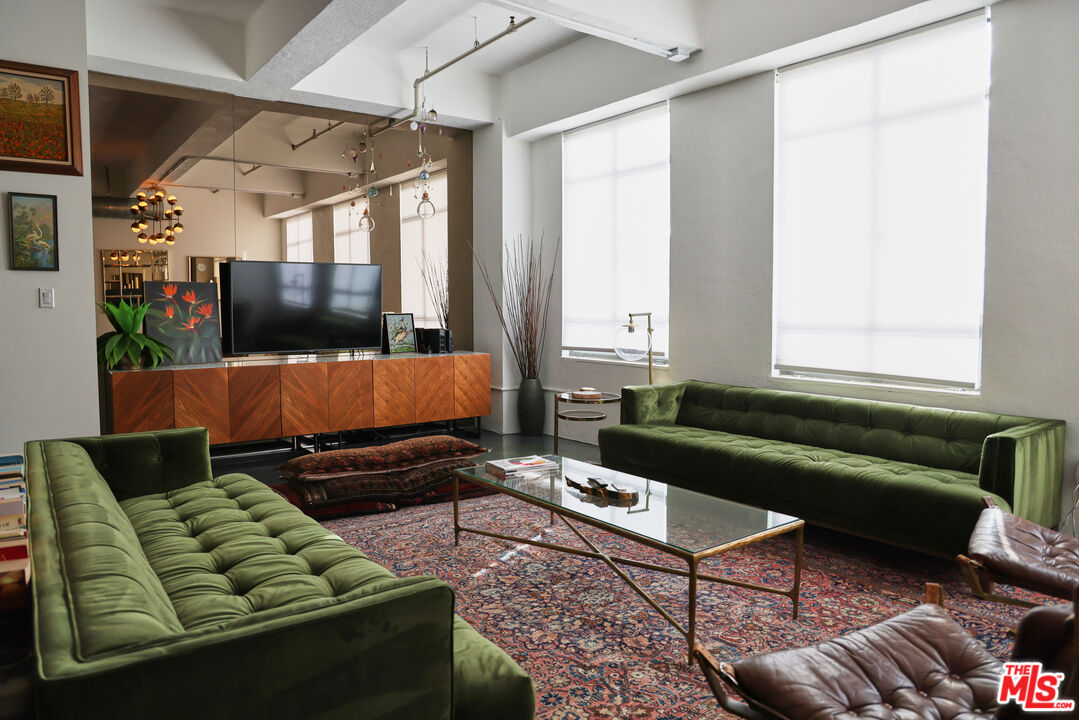 849 South Broadway, Unit 906 Los Angeles, CA 90014 - Photo 7 of 65 a living room with furniture and a window