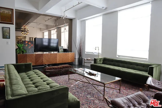 a living room with furniture and a chandelier