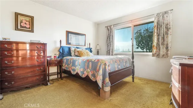 a bedroom with a bed a table and chair