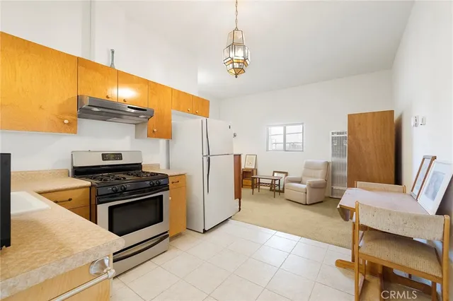 a view of a livingroom with workspace and a window