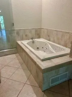 a bath tub sitting next to a white sink
