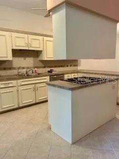 a kitchen with stainless steel appliances granite countertop a sink and cabinets