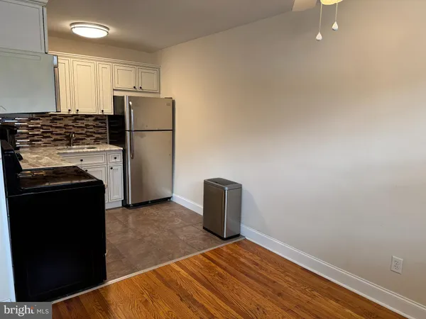 a kitchen with a refrigerator and a stove