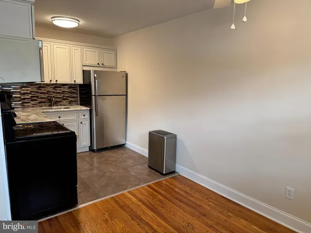 a kitchen with a refrigerator and a stove
