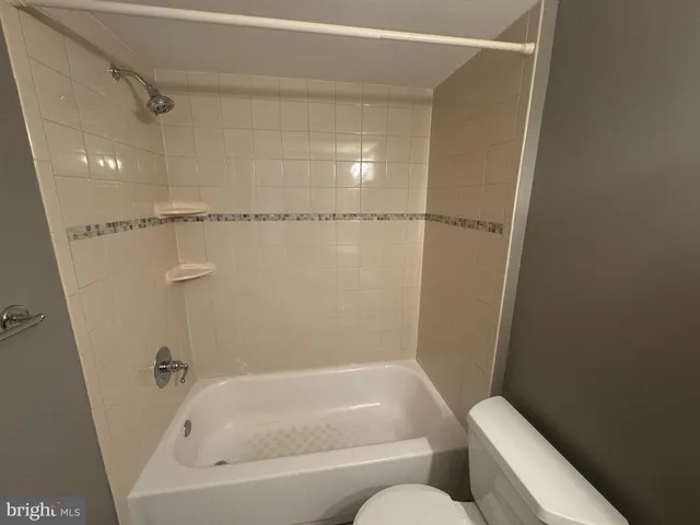 a bathroom with a bathtub and toilet