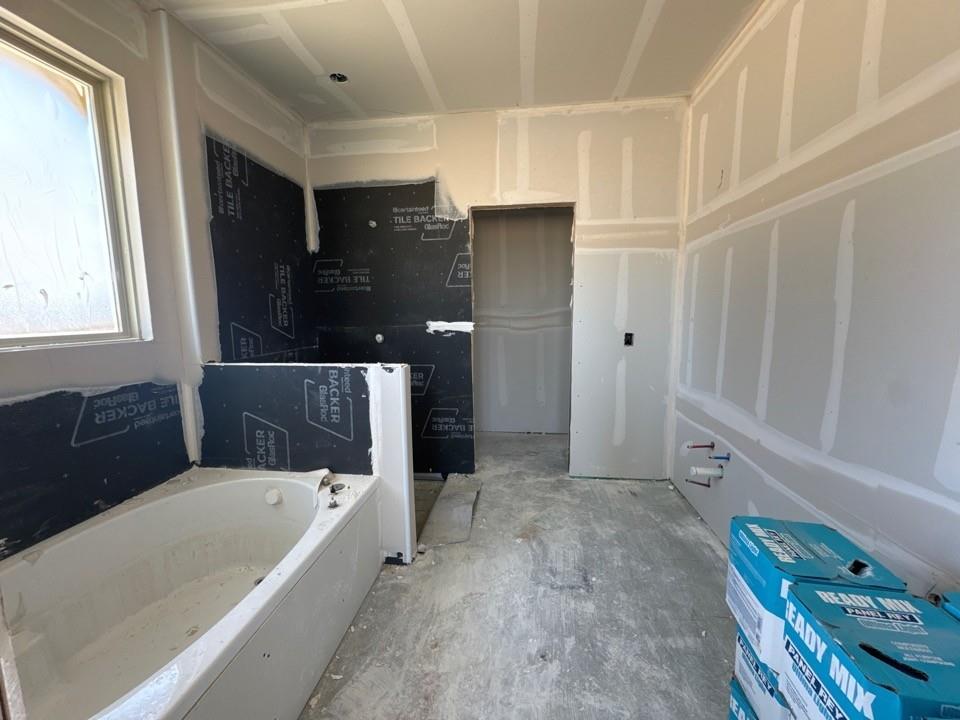 116 Snowy Owl Trail Rhome, TX 76078 - Photo 12 of 14 a bathroom with a bathtub and a shower