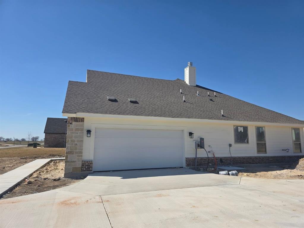 116 Snowy Owl Trail Rhome, TX 76078 - Photo 3 of 7 a front view of a house with a yard