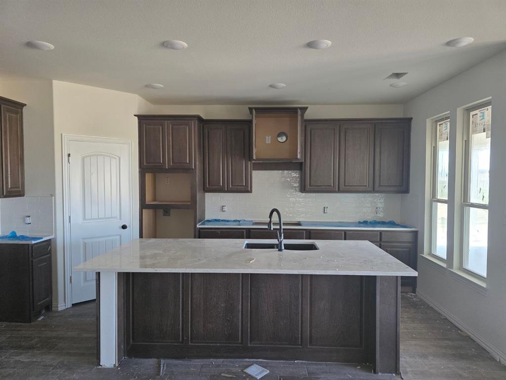 116 Snowy Owl Trail Rhome, TX 76078 - Photo 5 of 7 a kitchen with a sink cabinets and window