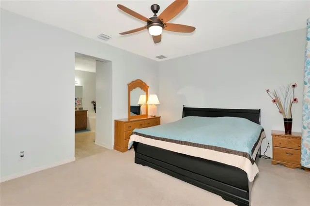 a bed room with a bed and a chandelier