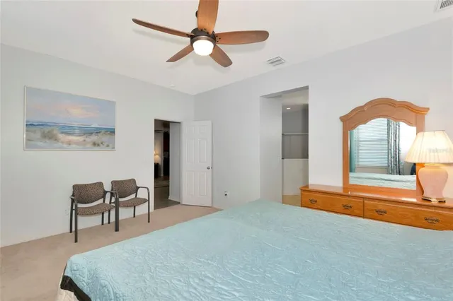 a bedroom with furniture and a ceiling fan