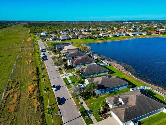 an aerial view of residential houses with outdoor space and swimming pool