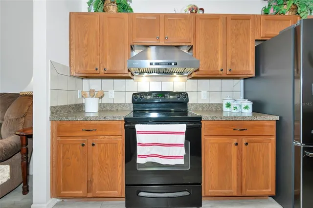 a kitchen with stainless steel appliances granite countertop a stove and a microwave